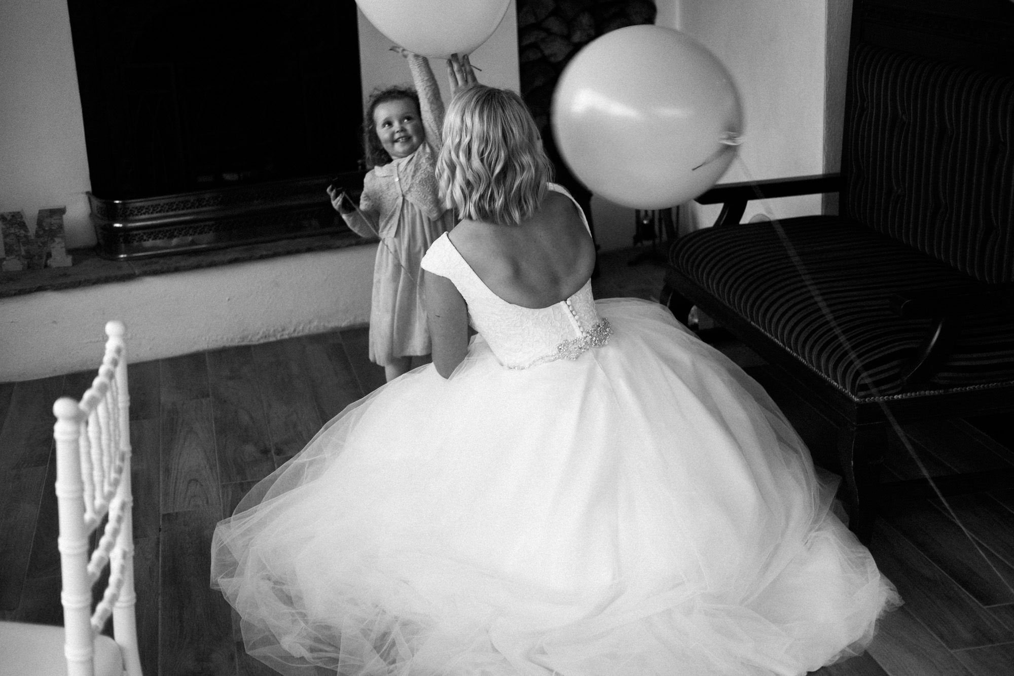 bride and flower girl playing with baloon