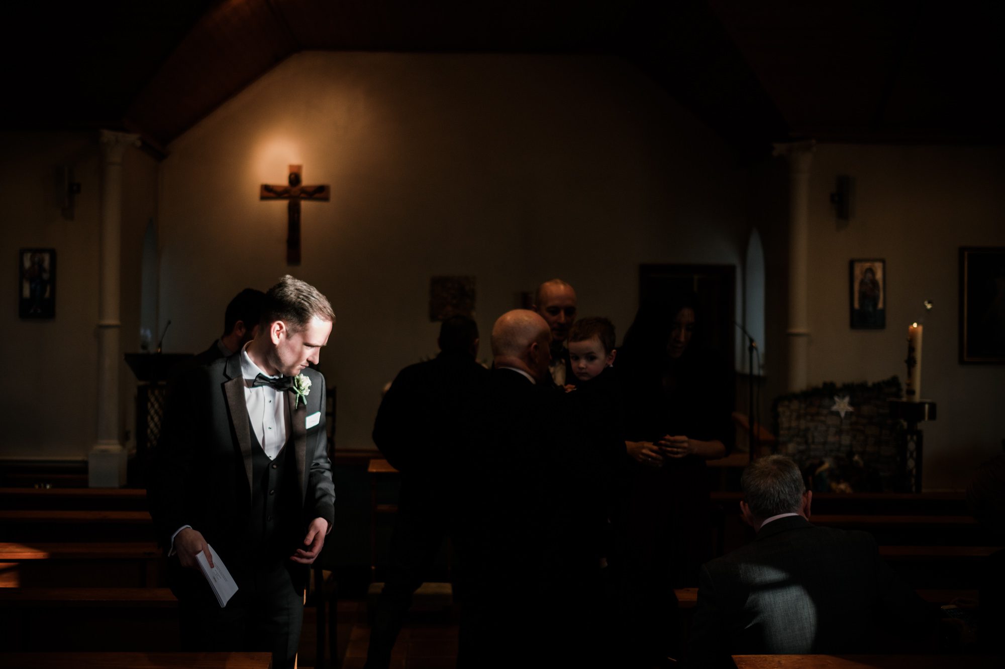 groom in dark church