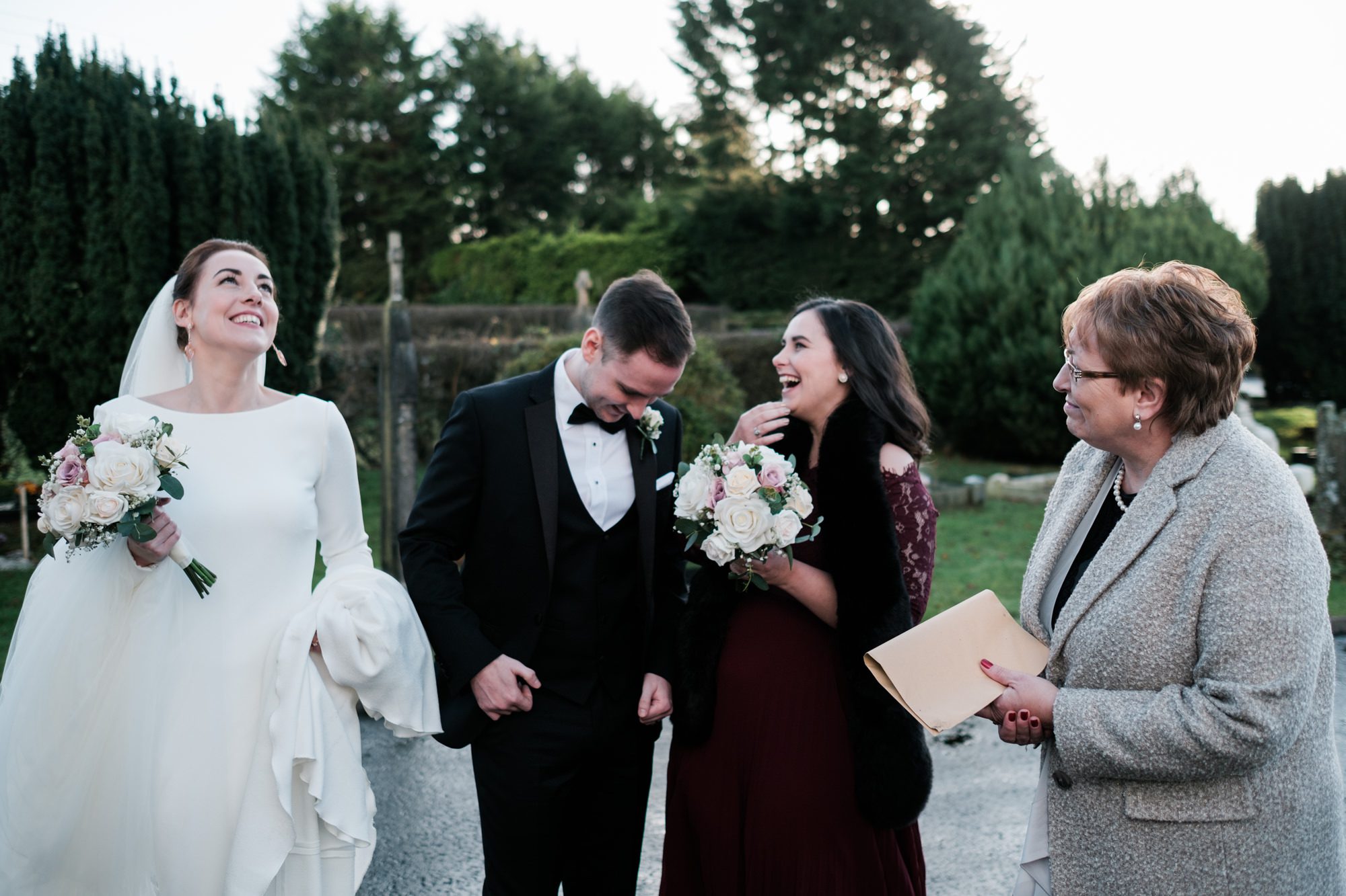 giggles outside of church after wedding ceremony