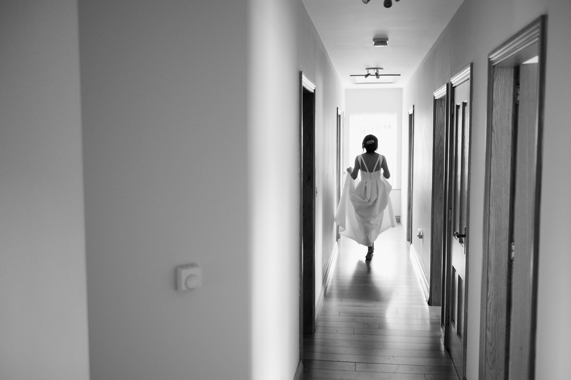 bride skipping down hallway