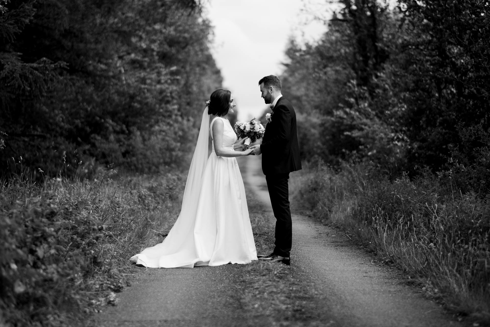 bride and groom in countryside lane