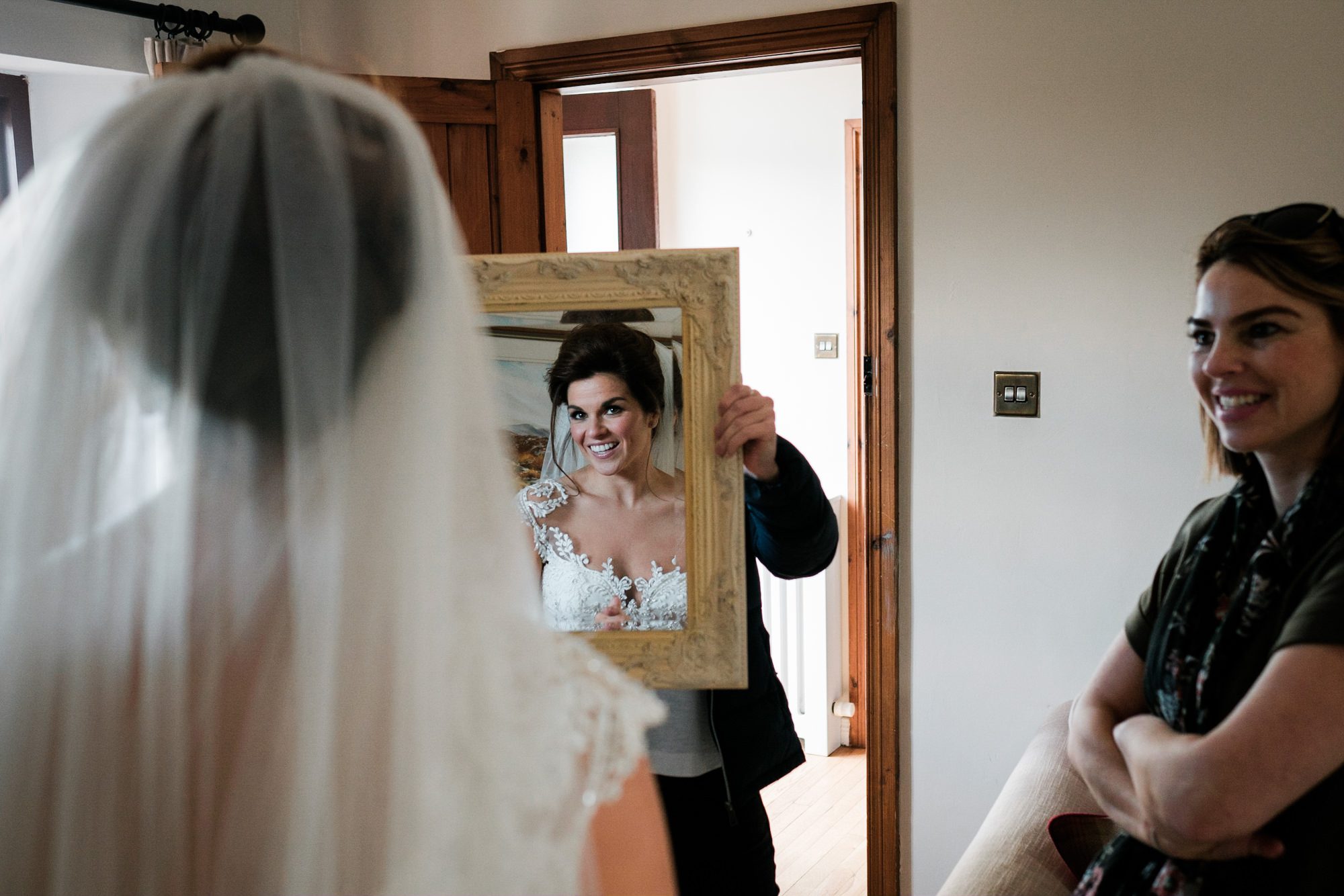 bride sees herself in mirror