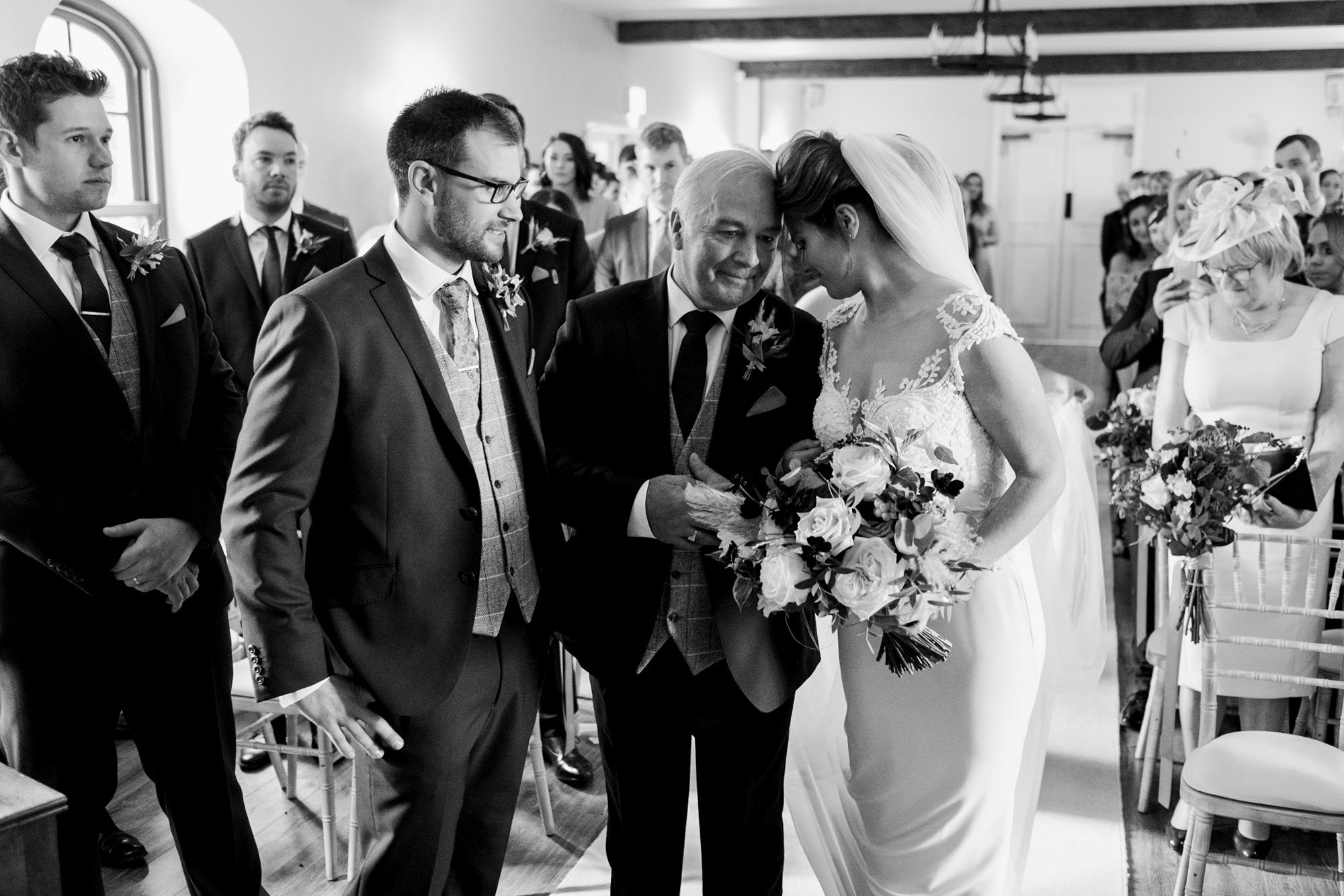 bride and her father sharing moment at top of aisle