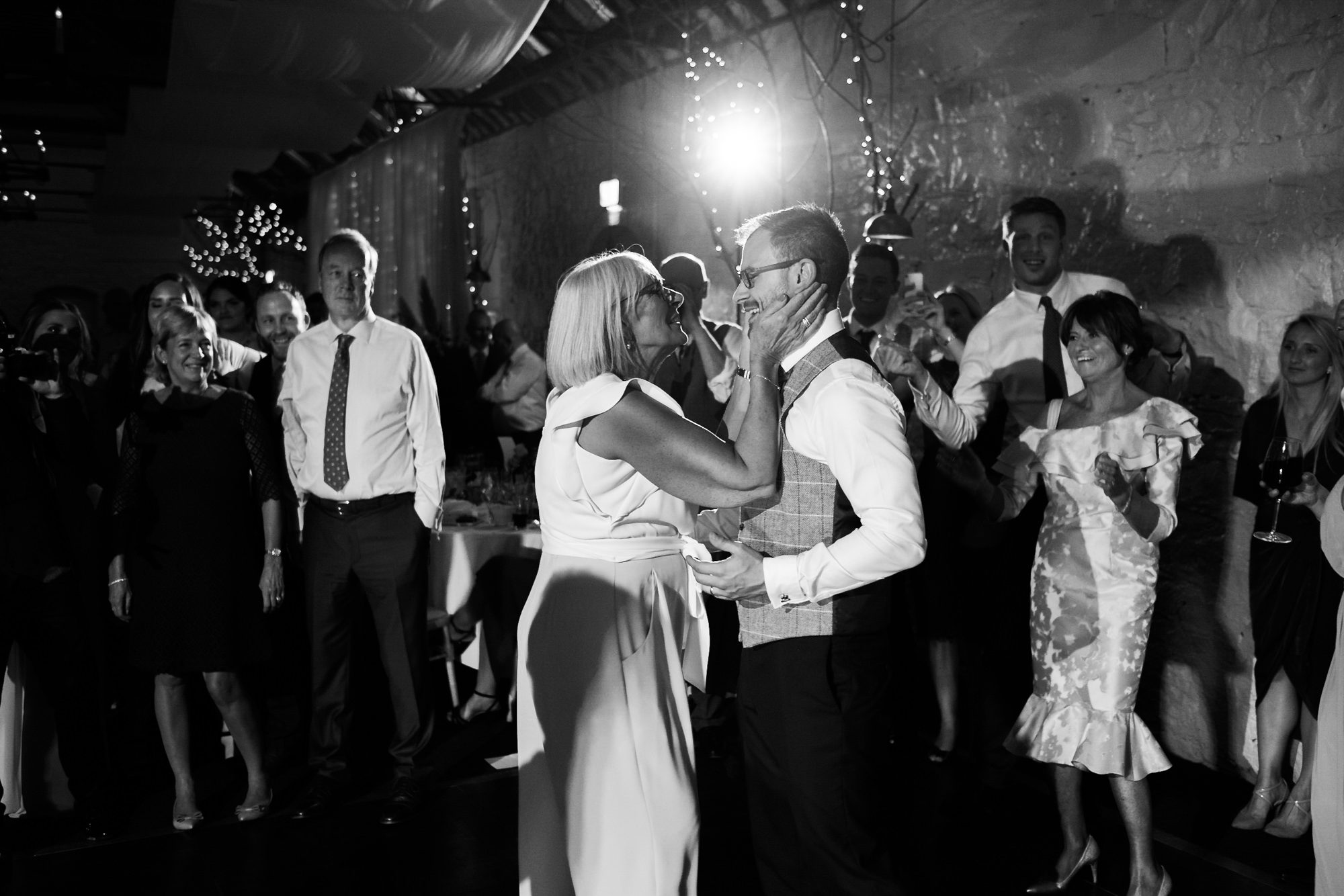 groom embraced by his mother on dance floor at Larchfield
