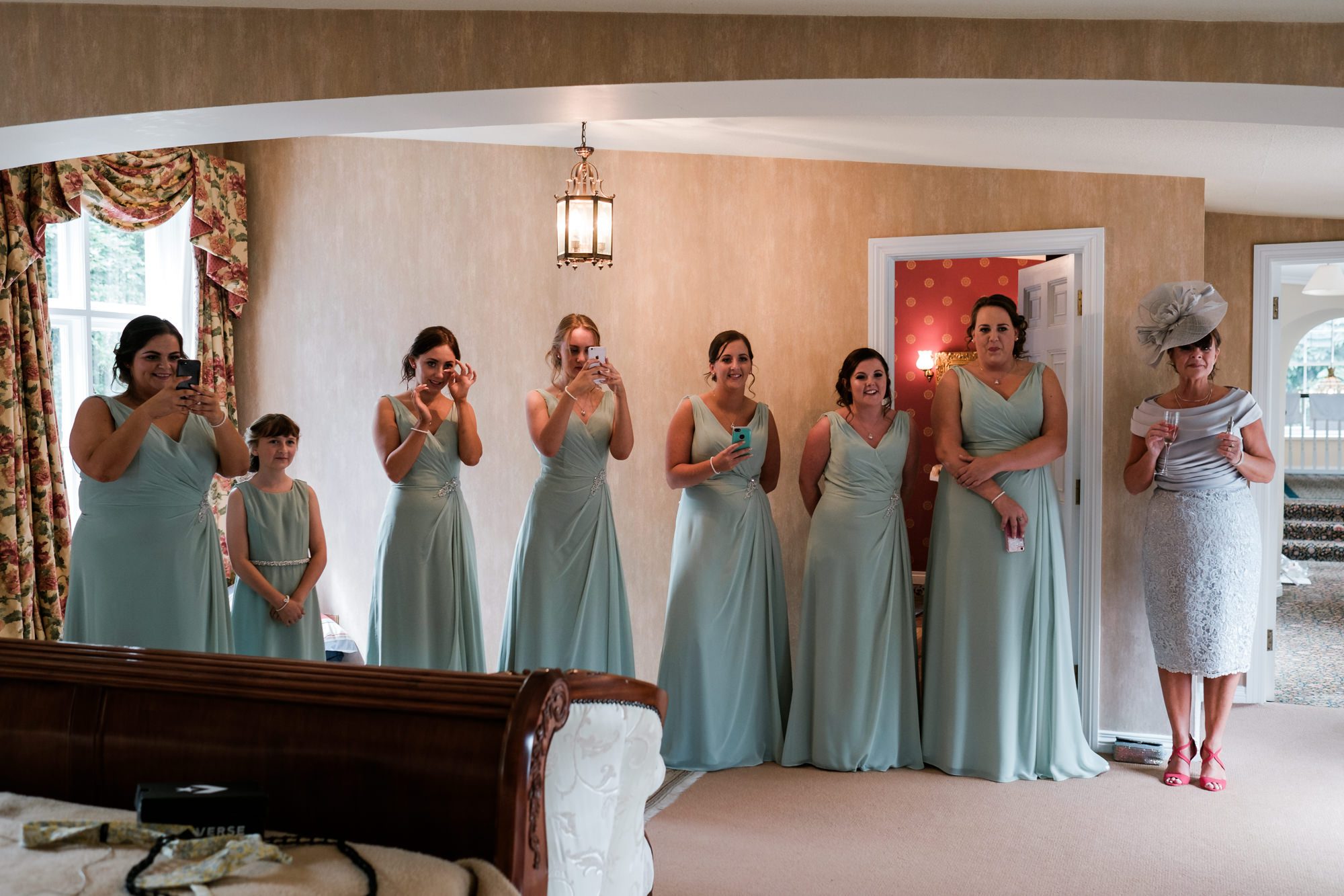 bridesmaids get first look at bride in her dress