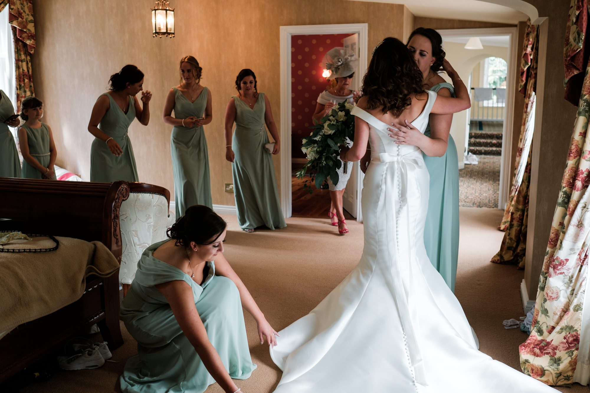 bridesmaids tending to bride