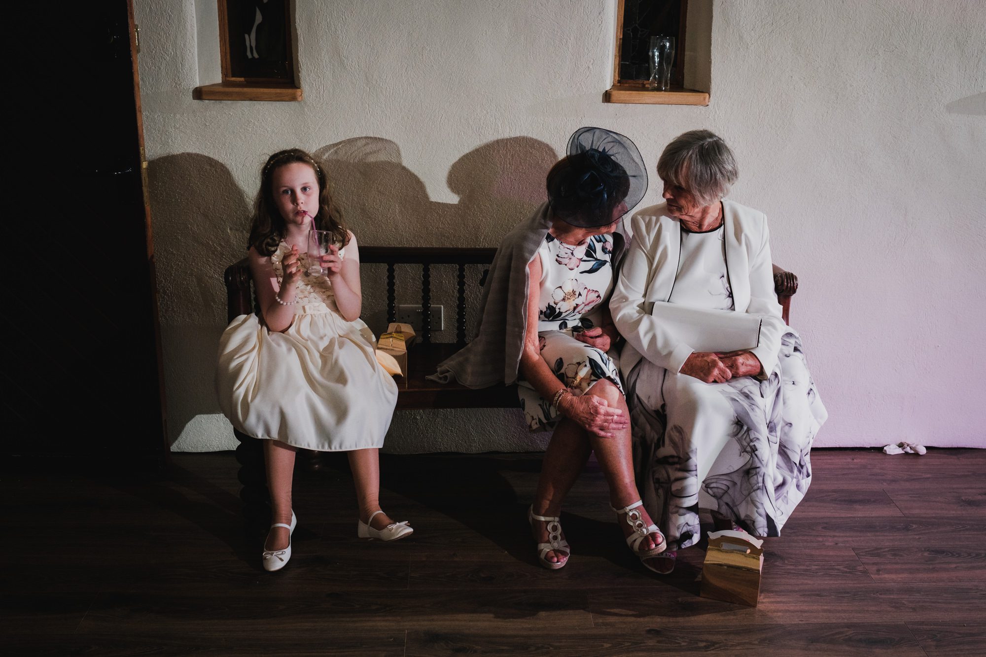 two old ladies chatting before the first dance, with little girl looking at me