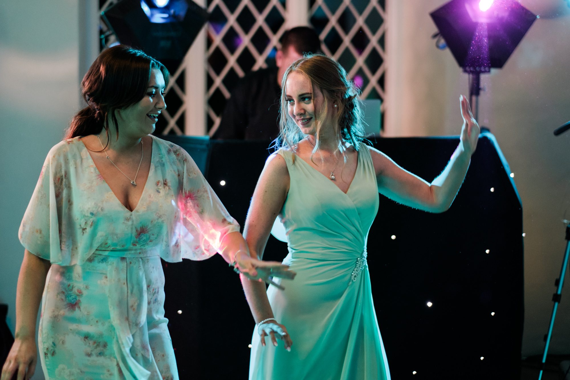 bridesmaid and friend dancing at wedding reception