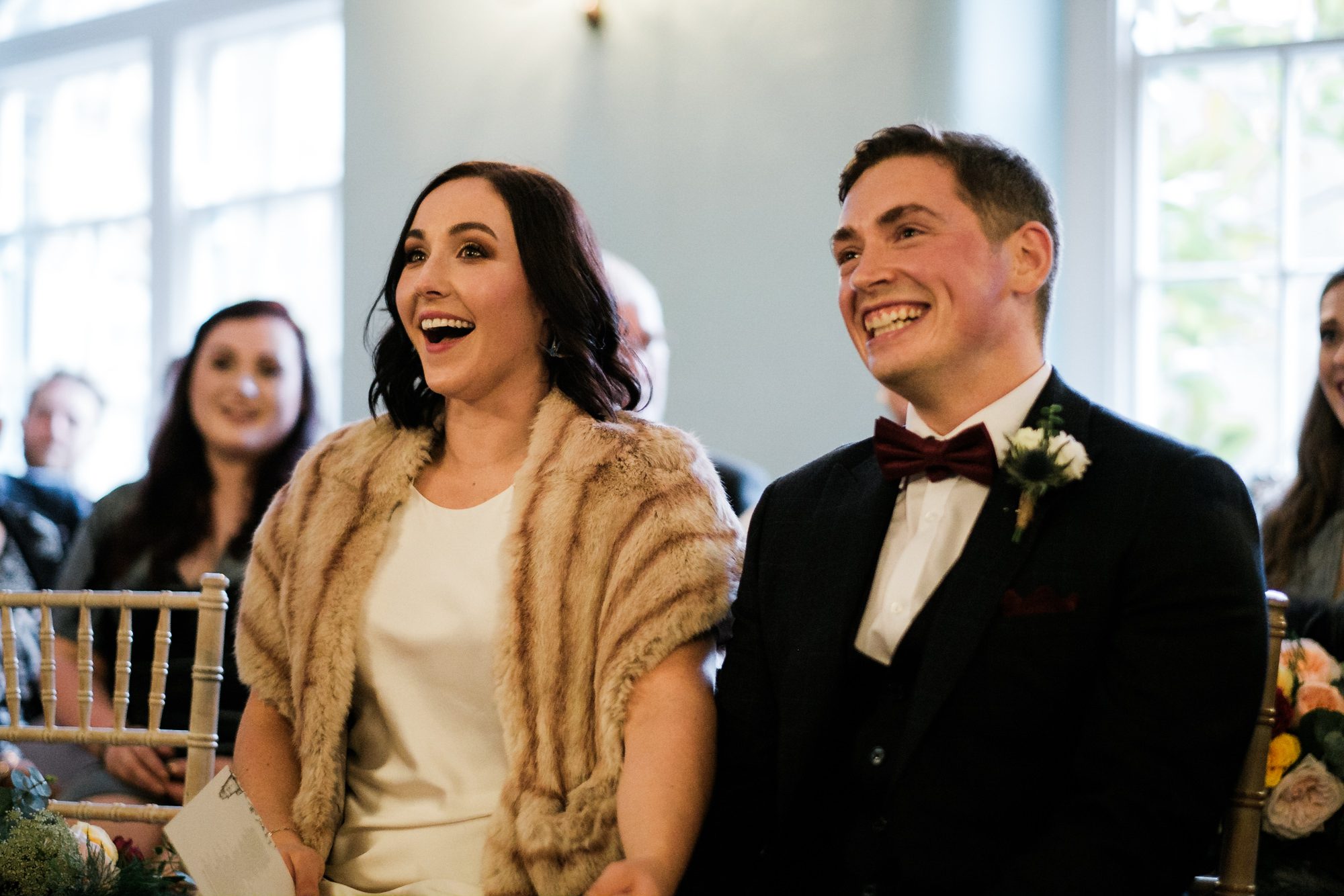 bride laughing at groom's words about her
