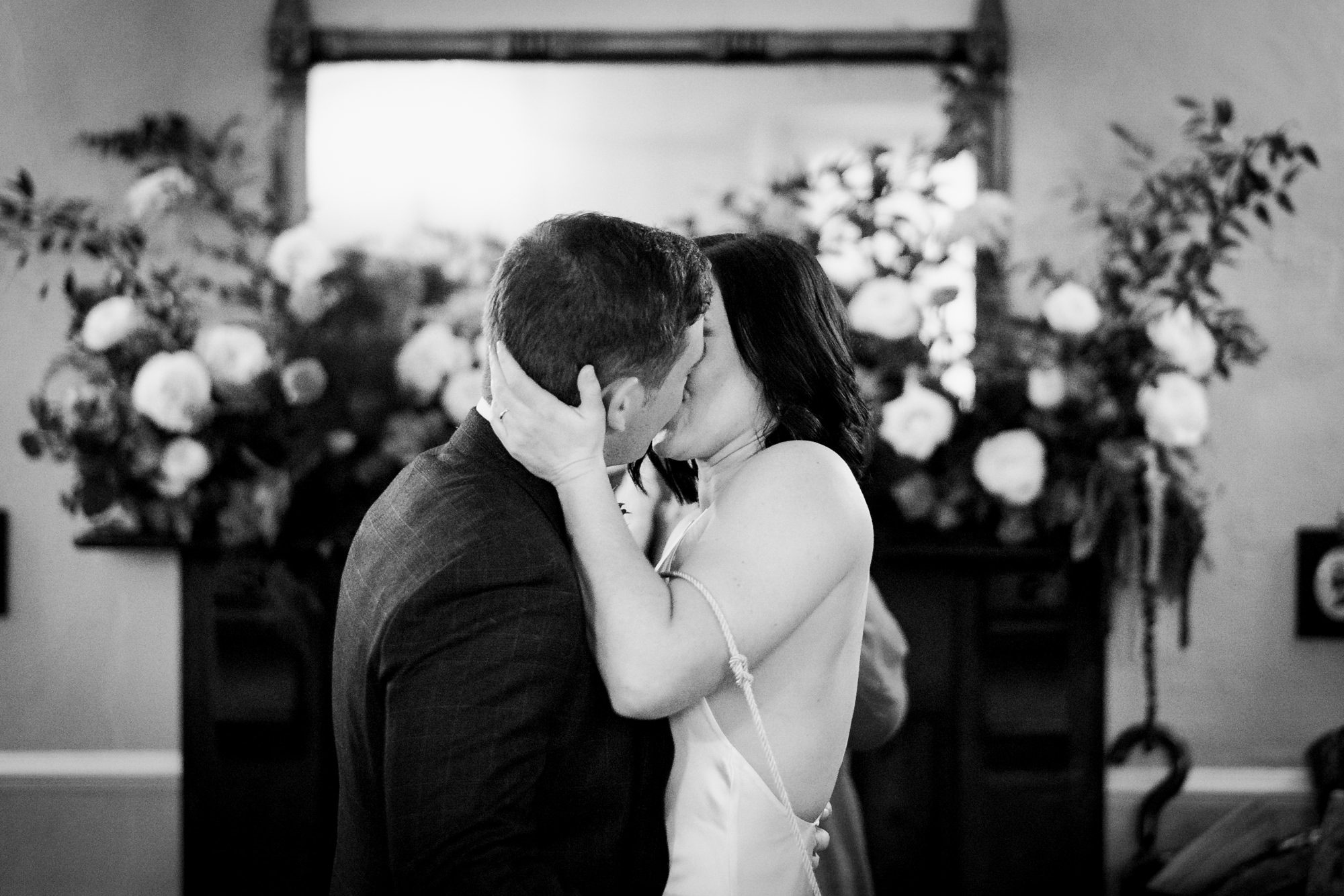 bride and groom kissing in ceremony
